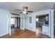 Inviting living room with hardwood floors, ceiling fan, and doorways leading to the kitchen and other rooms at 312 Lake Moultrie Dr, Bonneau, SC 29431