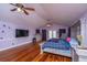 The main bedroom is spacious, with hardwood floors, a ceiling fan, and soft purple walls at 312 Lake Moultrie Dr, Bonneau, SC 29431