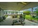 Spacious covered patio with concrete flooring, ceiling fan, and yard views at 312 Lake Moultrie Dr, Bonneau, SC 29431