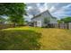 Large backyard featuring a manicured lawn, a wooden fence and a detached shed at 315 Courtney Round, Summerville, SC 29486