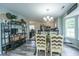 Open dining room featuring stylish decor, a modern light fixture, and seamlessly connects to the adjacent kitchen at 315 Courtney Round, Summerville, SC 29486