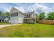 Charming two-story home boasts a welcoming front porch and well-manicured lawn at 315 Courtney Round, Summerville, SC 29486