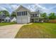 Two-story home featuring a two-car garage, a front porch and a well-manicured lawn at 315 Courtney Round, Summerville, SC 29486