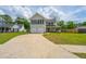 Inviting two-story home with a long driveway and a well-maintained lawn at 315 Courtney Round, Summerville, SC 29486