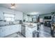 Modern kitchen featuring granite countertops, stainless steel appliances, and a breakfast bar that opens to the living room at 315 Courtney Round, Summerville, SC 29486