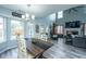 Bright living room with hardwood floors, large windows, modern lighting, and open access to the dining area at 315 Courtney Round, Summerville, SC 29486