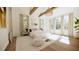 Well-lit main bedroom with beamed ceiling, sitting area, multiple windows, and plush bedding at 33 Duany Rd, Mount Pleasant, SC 29464