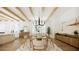 Open-concept dining room with wood table, modern chandelier, beamed ceiling, and wood floors at 33 Duany Rd, Mount Pleasant, SC 29464