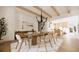 Sunlit dining room with wood table, modern chandelier, beamed ceiling, and an adjacent view of the kitchen at 33 Duany Rd, Mount Pleasant, SC 29464