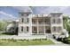 Elegant two-story home with a charming balcony, shutters, and a well-manicured lawn on a sunny day at 33 Duany Rd, Mount Pleasant, SC 29464