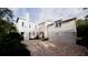 Well-maintained two-story home with a brick driveway and attached garage, showcasing its charming architecture at 33 Duany Rd, Mount Pleasant, SC 29464