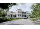 Elegant home with manicured landscaping and a paved driveway, showcasing its inviting curb appeal and charming architecture at 33 Duany Rd, Mount Pleasant, SC 29464