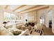 Bright living room featuring a fireplace, wood beams, neutral decor, and an opening to the outdoor pool area at 33 Duany Rd, Mount Pleasant, SC 29464