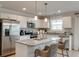 Stylish kitchen boasts white cabinetry, stainless steel appliances, and a granite island at 333 O'Leary Circle, Summerville, SC 29483