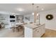 Open-concept living room with modern kitchen island, dining area, and fireplace, perfect for entertaining at 333 O'Leary Circle, Summerville, SC 29483