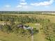 Aerial view of home with shed in wooded lot featuring expansive private yard and bright blue skies at 341 Sugar Hill Rd, Saint George, SC 29477