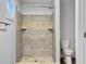Bathroom features gray and tan tiled shower with dual inset shelving and a corner octagon window at 341 Sugar Hill Rd, Saint George, SC 29477