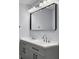 Bathroom with double sinks, gray cabinets, black hardware, and a large mirror at 341 Sugar Hill Rd, Saint George, SC 29477