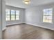 Well-lit bedroom featuring wood-look flooring and large windows for ample natural light at 341 Sugar Hill Rd, Saint George, SC 29477