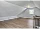 Bonus room with hardwood floors, neutral walls, trim, a window and staircase with wood railings at 341 Sugar Hill Rd, Saint George, SC 29477