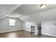 Bonus room with hardwood floors, neutral walls, trim, a window and staircase with metal balusters at 341 Sugar Hill Rd, Saint George, SC 29477