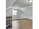 Bonus room with hardwood floors, neutral walls, trim, a window and staircase with metal balusters at 341 Sugar Hill Rd, Saint George, SC 29477