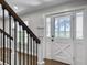 Bright entryway featuring a glass-paneled front door, staircase, and light-filled windows at 341 Sugar Hill Rd, Saint George, SC 29477