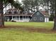 Charming two-story home with a welcoming front porch, lush lawn, and attached two car garage at 341 Sugar Hill Rd, Saint George, SC 29477