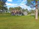 Charming gray home with front porch, mature trees, and spacious lawn at 341 Sugar Hill Rd, Saint George, SC 29477
