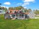Charming gray home with front porch, mature trees, and spacious lawn at 341 Sugar Hill Rd, Saint George, SC 29477