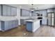 An open kitchen with light blue cabinets, stainless steel appliances, and quartz countertops at 341 Sugar Hill Rd, Saint George, SC 29477