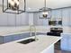 A modern kitchen with a stainless steel sink, grey cabinets, and quartz countertops at 341 Sugar Hill Rd, Saint George, SC 29477