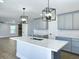 Spacious kitchen featuring a large island, quartz countertops, and modern light fixtures at 341 Sugar Hill Rd, Saint George, SC 29477