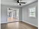 Living room with wood-look flooring leads to the open kitchen and dining area at 341 Sugar Hill Rd, Saint George, SC 29477