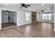 Spacious living room featuring ceiling fans, recessed lights, a brick fireplace, and new flooring at 341 Sugar Hill Rd, Saint George, SC 29477