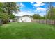 Expansive backyard with a lush lawn, privacy fence, and mature trees providing shade at 35 Campbell Dr, Charleston, SC 29407