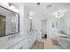 Bright bathroom showcasing double vanities, marble countertops, and a glass enclosed tub and shower at 35 Campbell Dr, Charleston, SC 29407