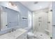 Bright bathroom featuring a glass shower with marble tile, vanity with quartz countertop, and white fixtures at 35 Campbell Dr, Charleston, SC 29407