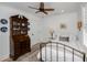 Cozy bedroom with a decorative ceiling fan, dark wood dresser and trim, and plantation shutters at 35 Campbell Dr, Charleston, SC 29407