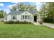 Charming one-story home with a well-manicured lawn, flower beds, and a classic white exterior at 35 Campbell Dr, Charleston, SC 29407