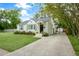 Inviting one-story home features a concrete driveway leading to a gated entrance and a well-maintained front lawn at 35 Campbell Dr, Charleston, SC 29407
