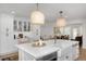Open kitchen with island, quartz countertops, stainless steel appliances, and stylish pendant lighting at 35 Campbell Dr, Charleston, SC 29407