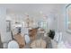 Open-concept kitchen and dining area with bright white cabinetry, island seating and shiplap walls at 35 Campbell Dr, Charleston, SC 29407