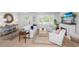 Cozy living room with shiplap walls, white furniture, a fireplace, and natural light from shuttered windows at 35 Campbell Dr, Charleston, SC 29407