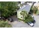 Backyard featuring a two story home with a driveway and several vehicles parked on gravel at 3.5 Kracke St # C, Charleston, SC 29403