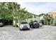 View of the property with ample parking in a gravel driveway and a yard with mature trees offering shade at 3.5 Kracke St # C, Charleston, SC 29403