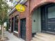 Exterior of BAD BUNNIES bar featuring red brick, steps, and a bright yellow sign at 3.5 Kracke St # C, Charleston, SC 29403