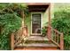 Charming front door with wood accents, surrounded by lush greenery and leading to a cozy home at 3.5 Kracke St # C, Charleston, SC 29403