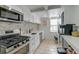 Modern kitchen with white cabinets, stainless steel appliances, and stylish backsplash offers a functional space at 3.5 Kracke St # C, Charleston, SC 29403