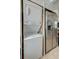 Convenient laundry area with stacked washer and dryer, next to stainless steel refrigerator at 3.5 Kracke St # C, Charleston, SC 29403